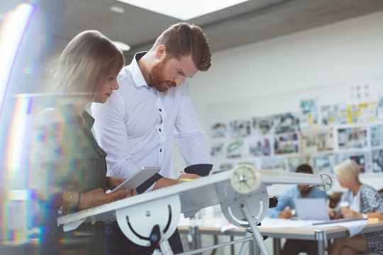 Executives working on drafting table