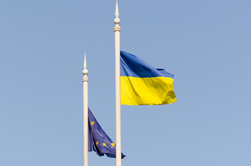 Ukrainian flag and the flag of the European Union against the sky
