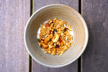 A bowl of granola with nuts and dried fruit for breakfast
