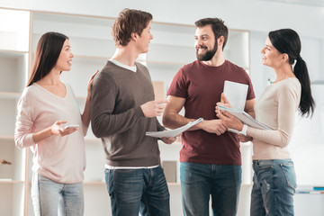 Successful project. Happy positive students smiling while discussing their successful university project