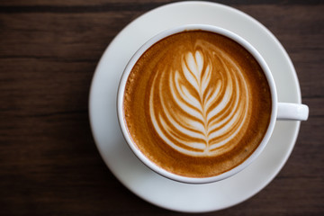 Cup of coffee latte on wood