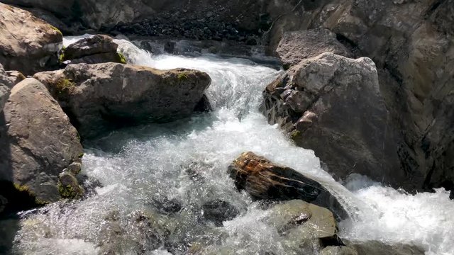 Slow motion shot of water from a mountain water fall going down