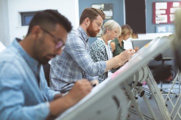Executives working on drafting table
