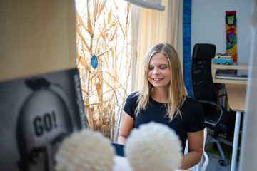 Young businesswoman with her computer, working in the coworking preparing her business idea