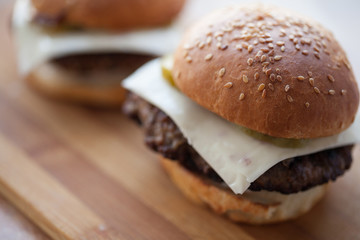 background of homemade buns with sesame seeds for hamburgers. made at home bread.
