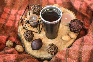 Autumn wooden decor with white cup of tea  and candles.