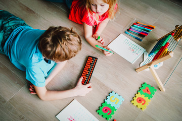 kids- boy and girl- learning numbers, arithmetic, abacus calculation