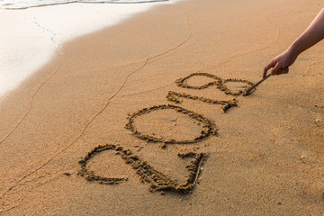Write 2018  on a beach sand