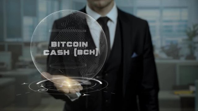 Male broker, head of crypto currency startup shows words Bitcoin Cash BCH on his hand. Entrepreneur in suit holds cyber Earth hologram, presenting virtual technologies.