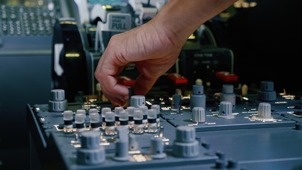 Panel of switches on an aircraft flight deck. Pilot controls the aircraft.