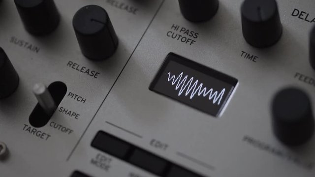 Music composer creating waveform on synthesiser analog sampler