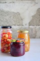 Variety of preserved food in glass jars - pickles, jam, marmalade, sauces, ketchup. Preserving vegetables and fruits. Fermented food. Autumn canning. Conservation of harvest.