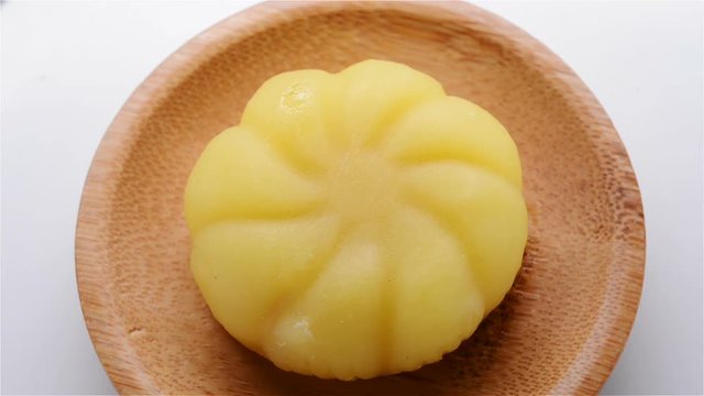 top view yellow morden moon cake rotating close up