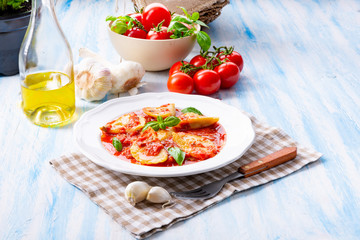 Delicious pasta - ravioli in tomato sauce with basil