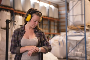 Female worker checking time on smart watch