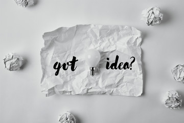 top view of power saving light bulb on crumpled paper with "got idea?" inspiration
