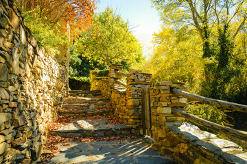 Stone stairway and wall in autumn among trees in Umbralejo Guadalajara
