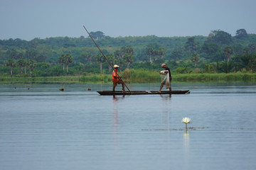 Fishermen in a conoe in the mono delta in Togo - obrazy, fototapety, plakaty