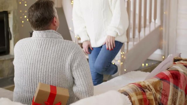 Man surprising his wife at christmas