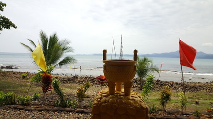 Pot with incense sticks at the coast of Sabang