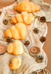 Flat lay composition of croissants with bumps and candles.