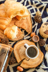 Warm flat lay composition with cup of coffee and croissants.