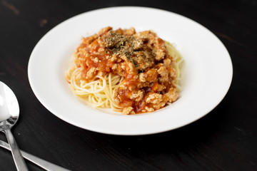 Spaghetti on black wooden background