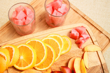 Composition of nectarine orange raspberry cocktails with watermelon