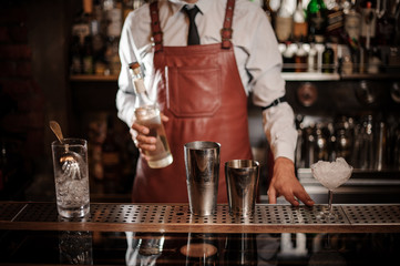 Bartender holding a bottle of alcoholic drink