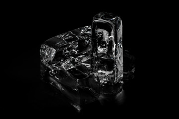 Four melting ice blocks isolated on the black background