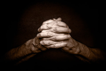 Man's Hands with crossed fingers. This is a classical gesture of a person praying God in the...