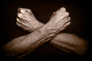 Man's crossed arms as a defense or shield to protect the body. A concept of security , a rampart...