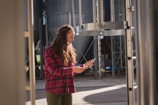 Female worker using digital tablet at bio gas plant