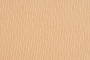 close up of a woolen fabric of beige color. Abstract background, empty template.