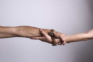 Man and woman hold and keep each other hands with smart watches. Hands of persons with smart watches