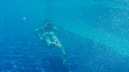 Photo of girl swims in the pool.
