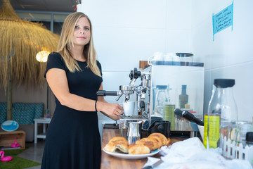 Young businesswoman having a coffee in the coworking