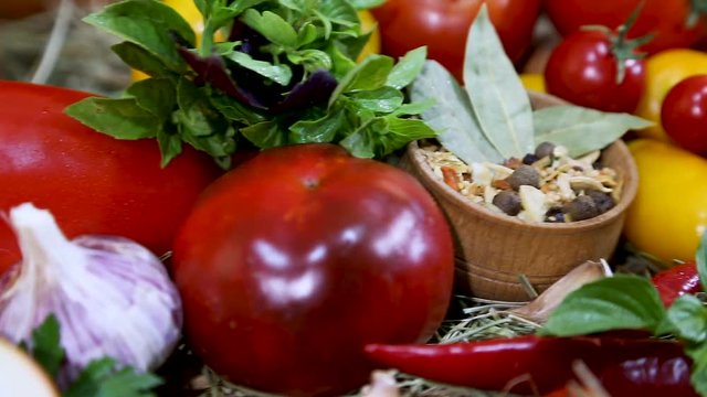 Red, yellow peppers, tomatoes, onions, red chili, garlic on fresh hay