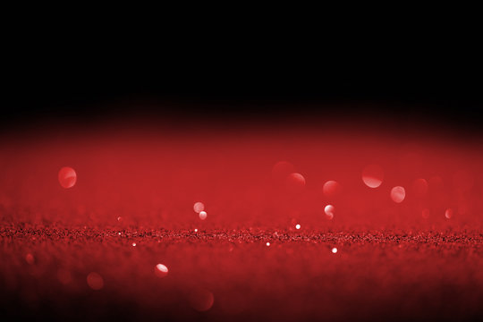 Sparking Red Glitter With Bokeh On Black Background