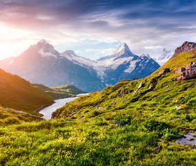 Dramatic summer view of the Bachalpsee lake with Schreckhorn and Wetterhorn peacks on the...