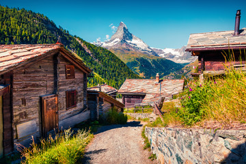 Sunny summer morning in Zermatt village with Matterhorn (Monte Cervino, Mont Cervin) peak on...