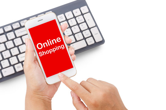 Hand holding online shopping on smartphone with keyboard.