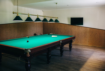 Billiard table with cue balls on it. Sports and indoor games free time concept.