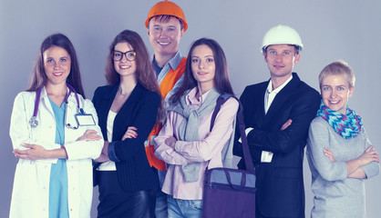Portrait of smiling people with various occupations holding blank billboard 