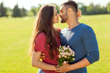 couple in love hugging in the park, concept of Valentine's Day