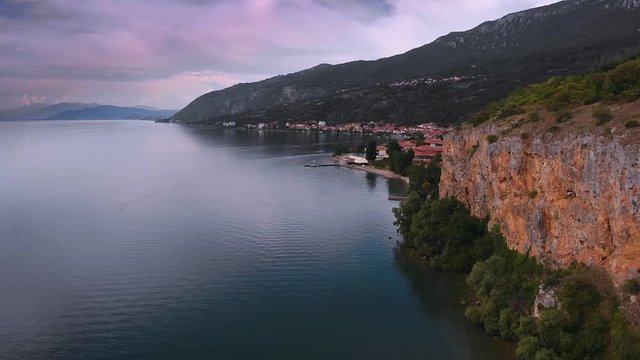 Aerial (drone) dolly forward shot of Macedonian shore in Ohrid Lake, Pesztani and Trpejca