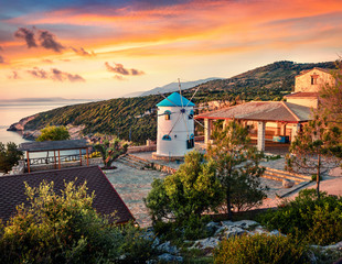 Fabulous morning scene of the contryside with Windmill. Colorful spring sunrise on the Zakynthos island, Korithi location, Ionian Sea, Greece, Europe. Beauty of countryside concept background.