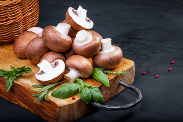 Fresh champignon mushrooms on wooden table