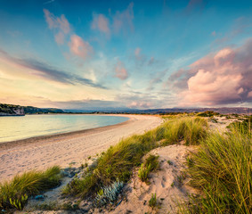 Colorful spring view of Voidokilia beach. Colorful sunset on the Ionian Sea, Pilos town location, Greece, Europe. Beauty of nature concept background. Artistic style post processed photo.