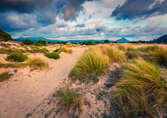 Colorful spring view of Voidokilia beach. Colorful sunset on the Ionian Sea, Pilos town location, Greece, Europe. Beauty of nature concept background. Artistic style post processed photo.